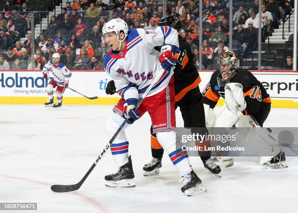 Tyler Pitlick of the New York Rangers screens Cam York and Carter Hart of the Philadelphia Flyers at the Wells Fargo Center on November 24, 2023 in...