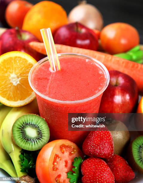 a strawberry smoothie surrounded by fruits - strawberry smoothie stock pictures, royalty-free photos & images