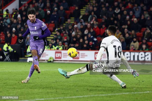 Liverpool's Hungarian midfielder Dominik Szoboszlai scores the team's second goal past Sheffield United's English goalkeeper Wes Foderingham during...