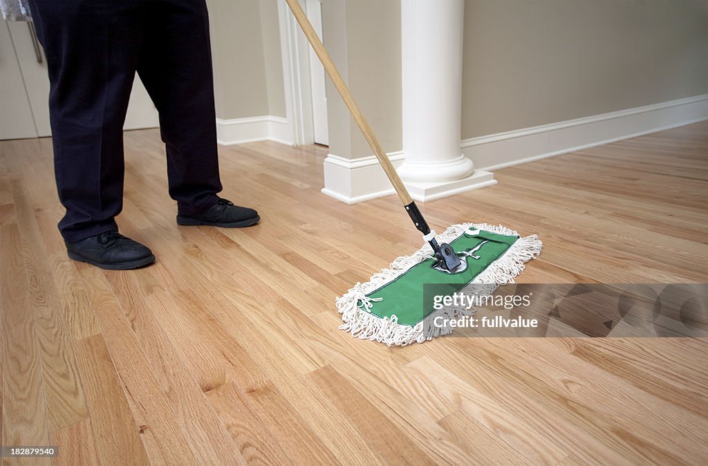 Janitor Dusting Hardwood Floor