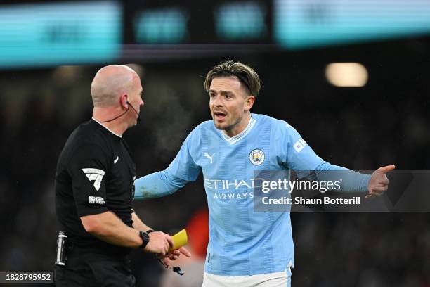 Referee, Simon Hooper shows a yellow card to Jack Grealish of Manchester City during the Premier League match between Manchester City and Tottenham...