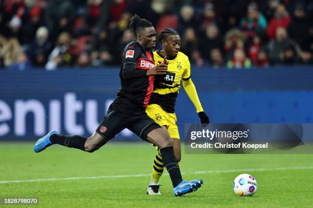 Jeremie Frimpong of Bayer Leverkusen battles for possession with Jamie Bynoe-Gittens of Borussia Dortmund during the Bundesliga match between Bayer...