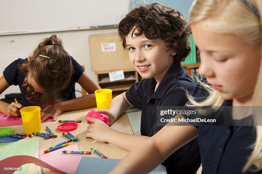 Young children make projects in art class