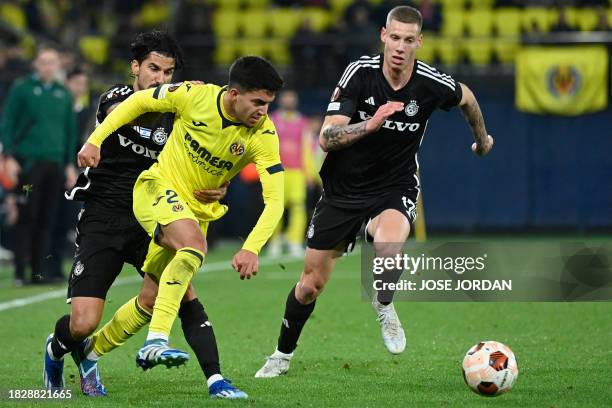 Maccabi Haifa's Israeli midfielder Lior Rafaelov and Maccabi Haifa's Israeli forward Suf Podgoreanu challenge Villarreal's Spanish forward Ilias...