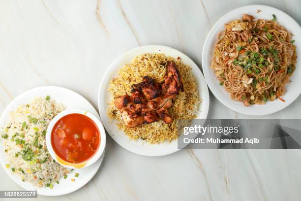 manchurian with rice, tikka biryani and noodle - biryani stock-fotos und bilder