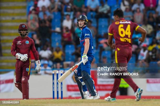 Zak Crawley of England reacts as Gudakesh Motie and Shai Hope of the West Indies celebrate during the 2nd ODI match between the West Indies and...