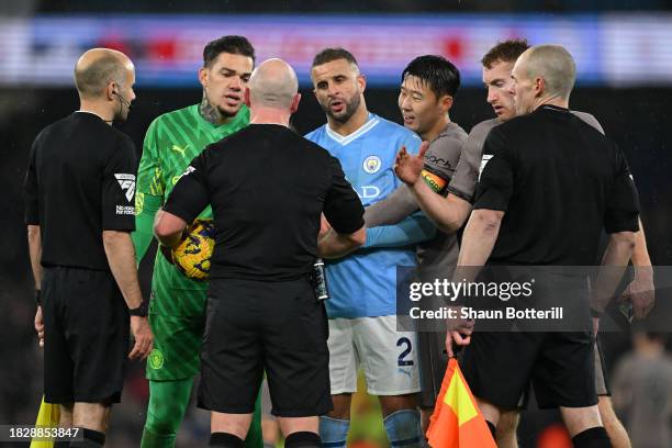 Ederson and Kyle Walker of Manchester City talk to Referee, Simon Hooper during the Premier League match between Manchester City and Tottenham...