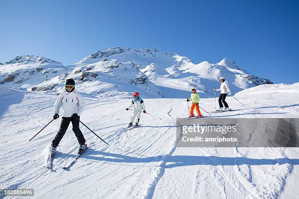 family skiing on sunny day - family skiing bildbanksfoton och bilder