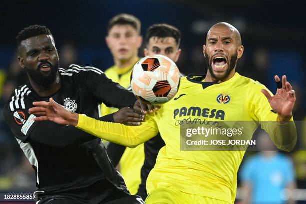 Maccabi Haifa's Haitian forward Frantzdy Pierrot vies with Villarreal's French midfielder Etienne Capoue during the UEFA Europa League 1st round...