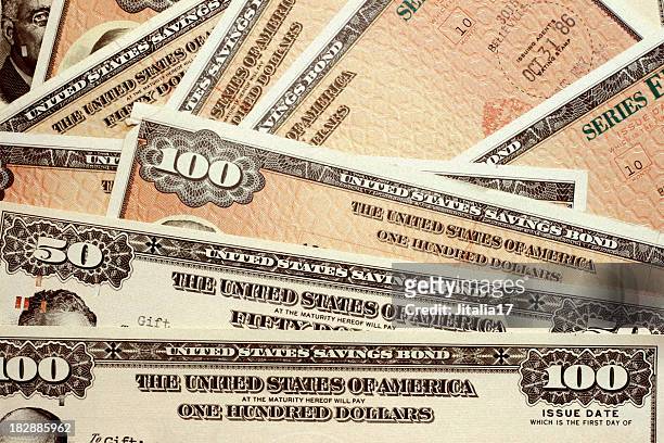 united states savings bonds of varying amounts - treasury stock pictures, royalty-free photos & images