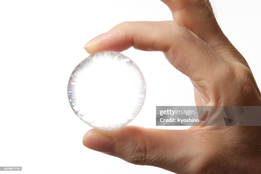 Isolated shot of holding a glass ball ageinst white background