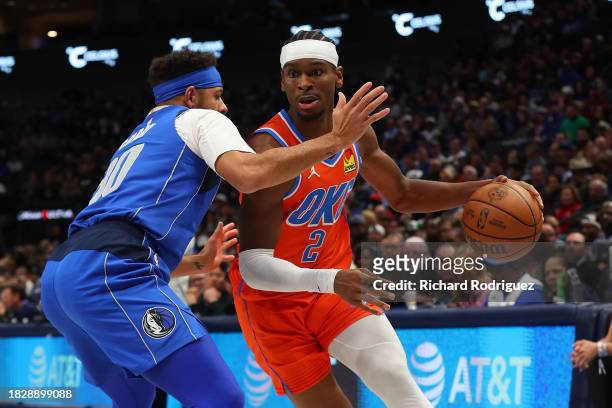 Seth Curry of the Dallas Mavericks guards Shai Gilgeous-Alexander of the Oklahoma City Thunder in the first half at American Airlines Center on...