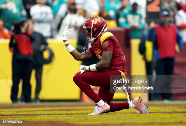 Dyami Brown of the Washington Commanders celebrates after scoring a touchdown against the Miami Dolphins during the second quarter of the game at...