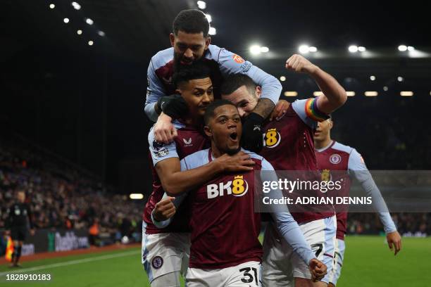 Aston Villa's Jamaican striker Leon Bailey celebrates with teammates after scoring the opening goal during the English Premier League football match...