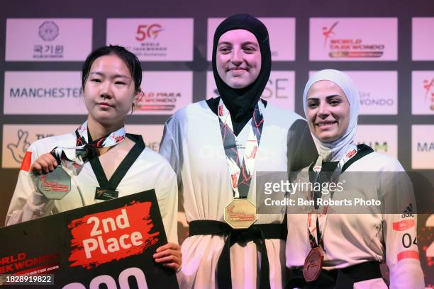 Silver medalist Mengyu Zhang of China, gold medalist Sarah Chaari of Belgium and bronze medalist Julyana Al-Sadeq of Jordan pose during the medal...