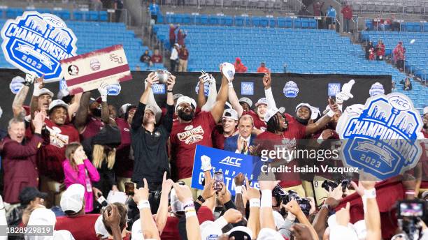 The Florida State Seminoles celebrate during the trophy ceremony after defeating the Louisville Cardinals during the ACC Championship at Bank of...