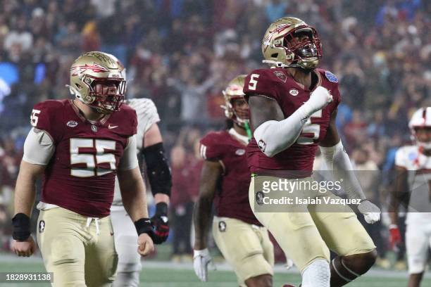 Jared Verse of the Florida State Seminoles reacts with Braden Fiske of the Florida State Seminoles after a sack against the Louisville Cardinals...