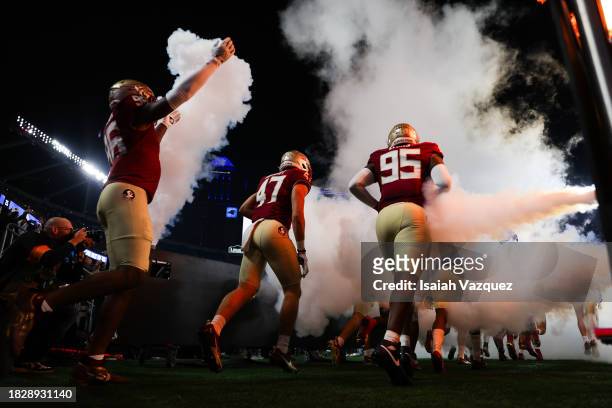 The Florida State Seminoles take the field to face the Louisville Cardinals during the ACC Championship at Bank of America Stadium on December 2,...