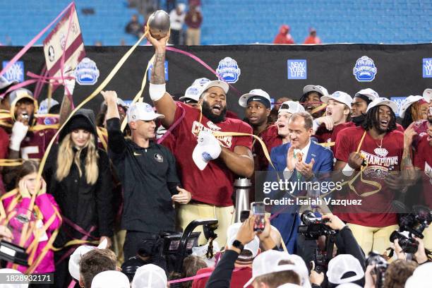 The Florida State Seminoles celebrate during the trophy presentation after defeating the Louisville Cardinals during the ACC Championship at Bank of...