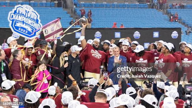 The Florida State Seminoles celebrate during the trophy presentation after defeating the Louisville Cardinals during the ACC Championship at Bank of...