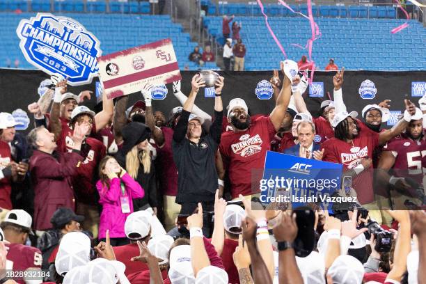 The Florida State Seminoles celebrate during the trophy presentation after defeating the Louisville Cardinals during the ACC Championship at Bank of...