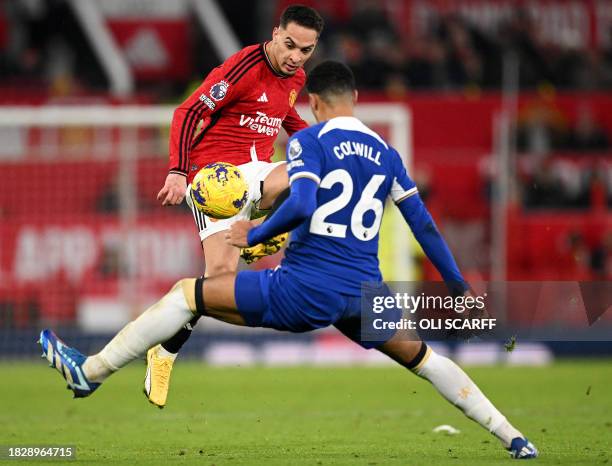 Manchester United's Brazilian midfielder Antony vies with Chelsea's English defender Levi Colwill during the English Premier League football match...