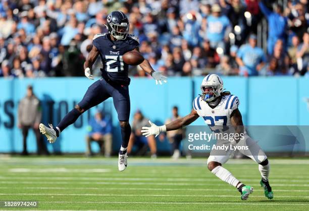 Roger McCreary of the Tennessee Titans and Trey Sermon of the Indianapolis Colts attempt to catch the ball during the first half at Nissan Stadium on...