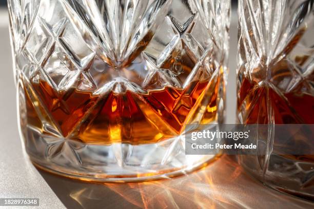 close up of a glass of whisky in the sunshine - long shadow shadow stock pictures, royalty-free photos & images