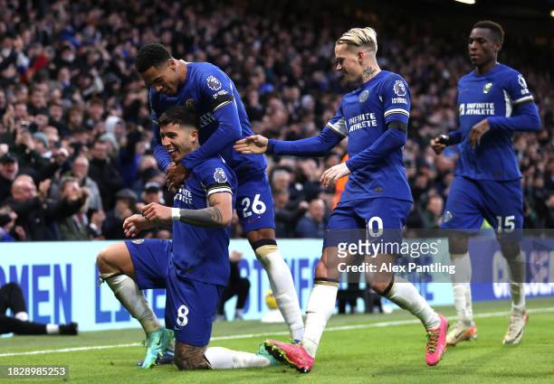 Enzo Fernandez of Chelsea celebrates with teammate Levi Colwill after scoring the team's third goal during the Premier League match between Chelsea...