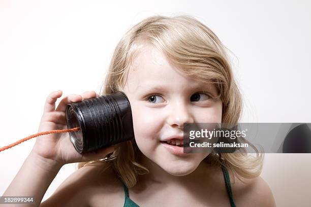 little girl with blonde hair talking on can phone - listening tin can stock pictures, royalty-free photos & images