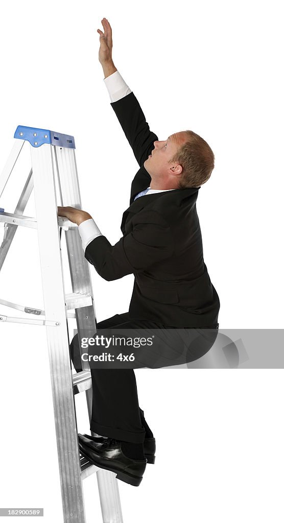 Businessman on step ladder