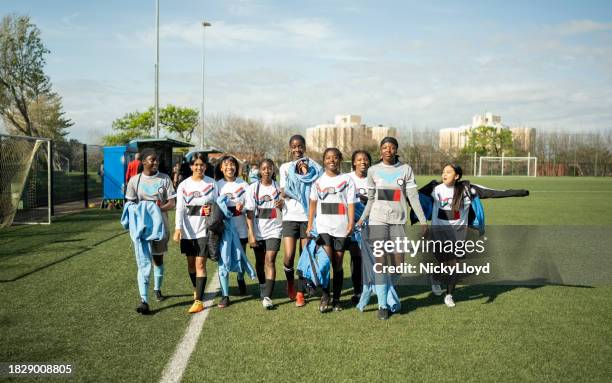 team of young female soccer players walking together after the practice session on sports field - south africa training session stock pictures, royalty-free photos & images