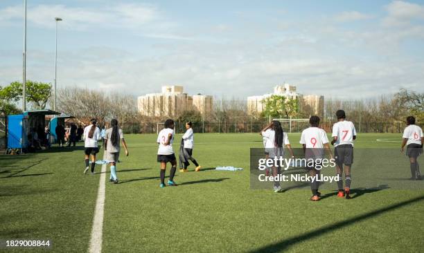 grupo de jóvenes jugadoras de fútbol practicando en el campo deportivo - entrenamiento deportivo fotografías e imágenes de stock