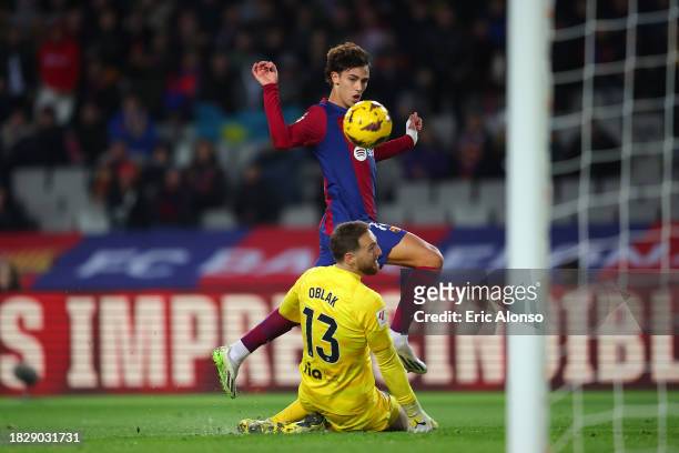 Joao Felix of FC Barcelona scores the team's first goal past Jan Oblak of Atletico Madrid during the LaLiga EA Sports match between FC Barcelona and...