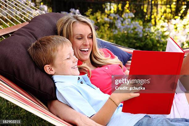 mother and son reading - gchutka stock pictures, royalty-free photos & images