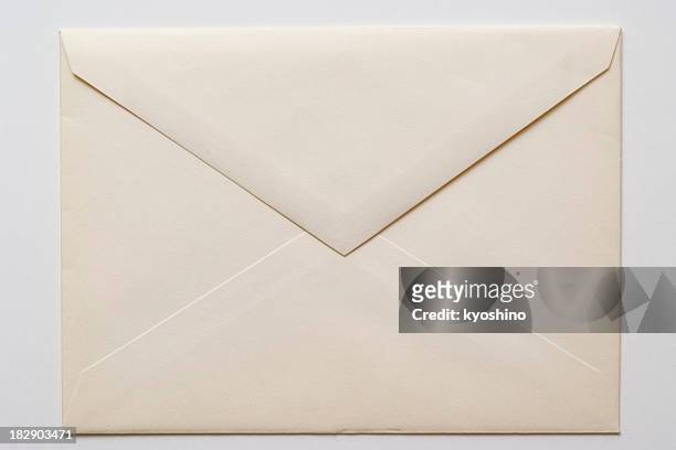 isolated shot of closed an old envelope on white background - correspondence stockfoto's en -beelden