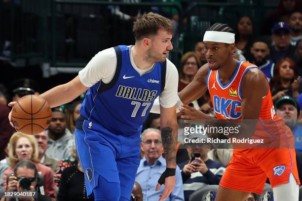Luka Doncic of the Dallas Mavericks looks for an opening against Shai Gilgeous-Alexander of the Oklahoma City Thunder at American Airlines Center on...