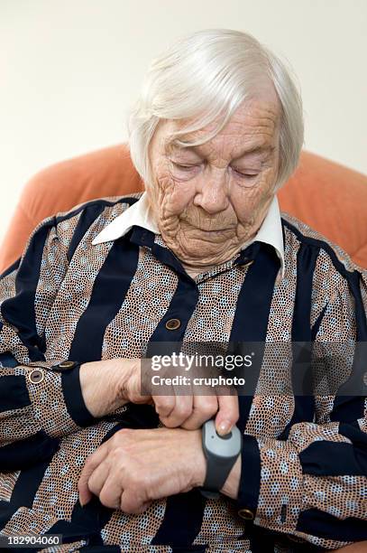 elderly lady using emergency call system - burglar alarm stock pictures, royalty-free photos & images