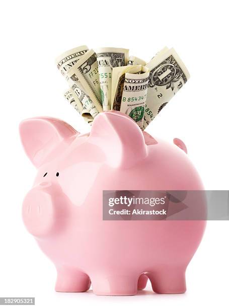 stuffed piggy bank with us dollars - piggy bank stock pictures, royalty-free photos & images