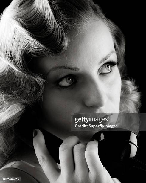 retro portrait of woman on old telephone. film-noir b&amp;w. - finger waves stockfoto's en -beelden