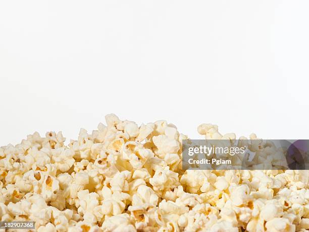 pile of theater popcorn - popcorn stock pictures, royalty-free photos & images