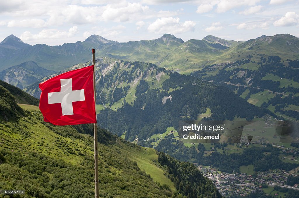 Swiss flag over Alps