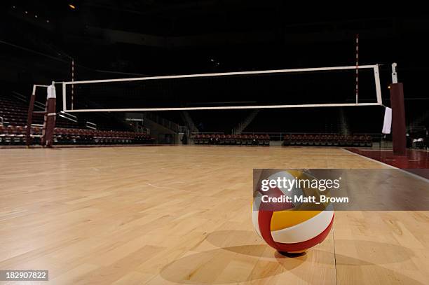 volleyball in an empty gym - indoor volleyball stock pictures, royalty-free photos & images