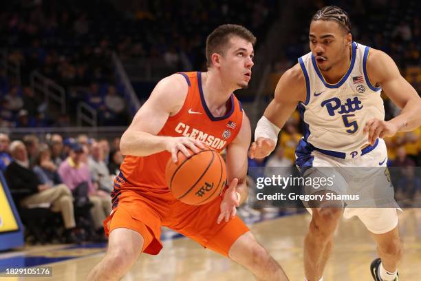 Joseph Girard III of the Clemson Tigers looks to take a second half shot next to Ishmael Leggett of the Pittsburgh Panthers at Petersen Events Center...