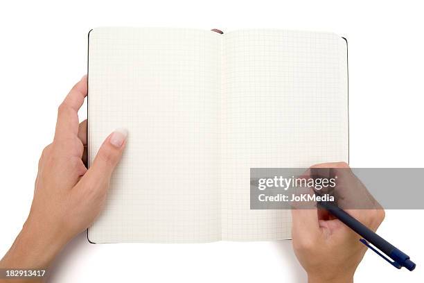 writing into a checkered notebook - pen and note pad stock pictures, royalty-free photos & images