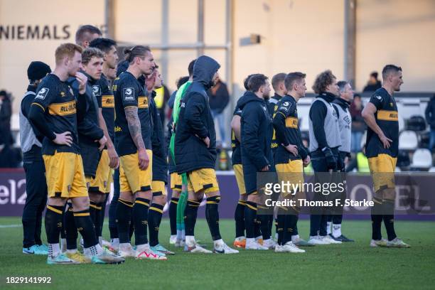 Players of Dresden stand dejected on the pitch after losing the 3. Liga match between SC Verl and Dynamo Dresden at SPORTCLUB Arena on December 03,...