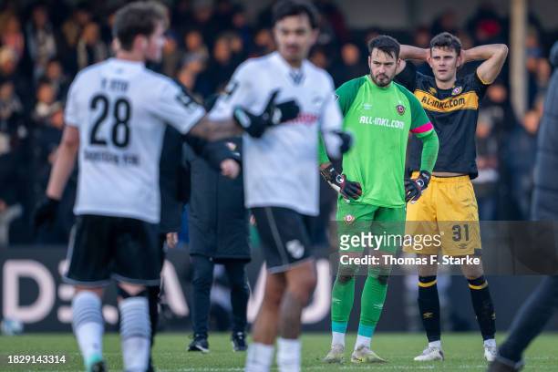 Stefan Drljaca and Jakob Lewald of Dresden stand dejected on the pitch after losing the 3. Liga match between SC Verl and Dynamo Dresden at SPORTCLUB...
