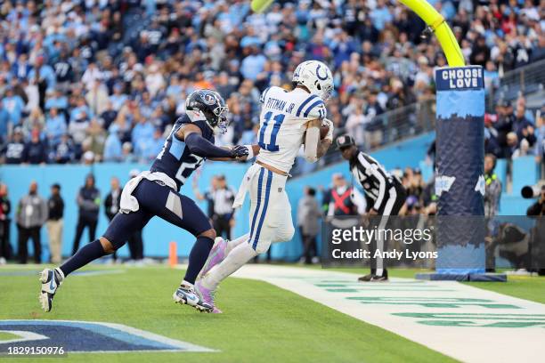 Michael Pittman Jr. #11 of the Indianapolis Colts catches a pass for a touchdown to defeat the Tennessee Titans in overtime at Nissan Stadium on...