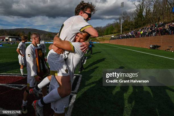 Casey McCloskey of the St. Olaf Oles celebrates with a teammate after a win Amherst Mammoths during the 2023 Division III Men's Soccer Championship...