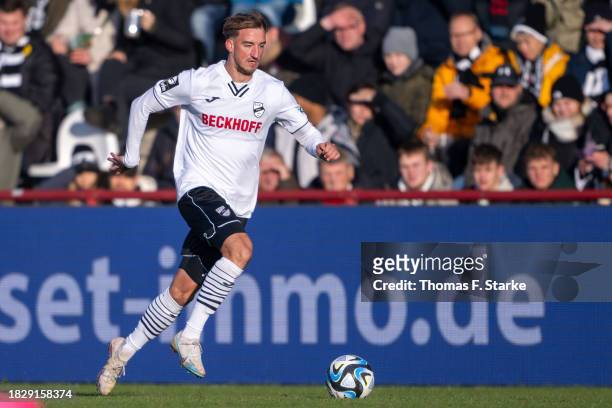 Michel Stoecker of Verl runs with the ball during the 3. Liga match between SC Verl and Dynamo Dresden at SPORTCLUB Arena on December 03, 2023 in...